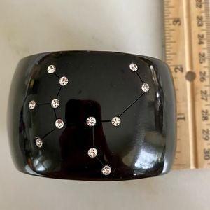 BCBG Sagittarius faux diamond star sign resin black cuff. Flexible sizing